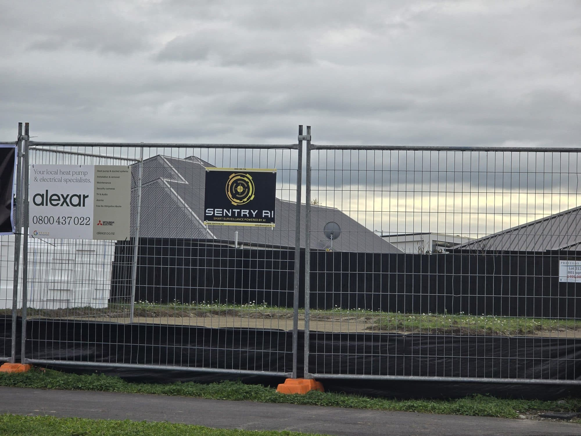 SentryAI signage on a construction site security fence
